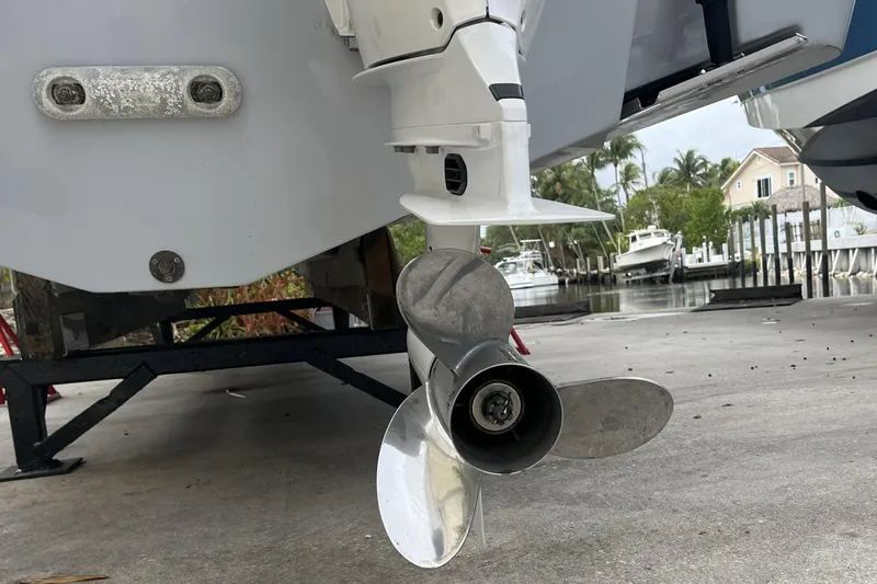 300 - 112 Brokerage Kevin Yacht Photos Pics 2023 Robalo R302 Center Console boat propeller on a trailer near a marina.