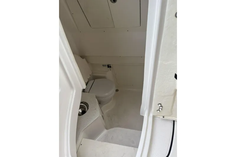 300 - 112 Brokerage Kevin Yacht Photos Pics Interior of 2023 Robalo R302 Center Console boat, featuring a compact marine toilet.