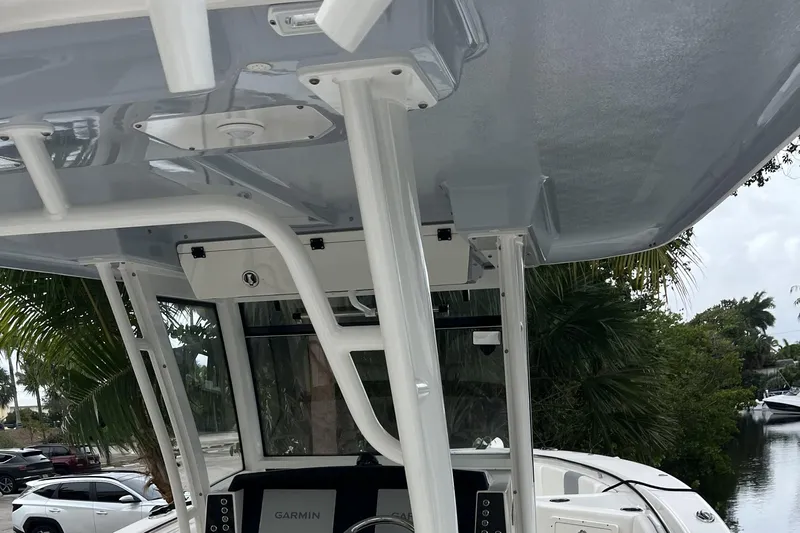 300 - 112 Brokerage Kevin Yacht Photos Pics 2023 Robalo R302 Center Console boat interior with Garmin electronics and overhead structure.