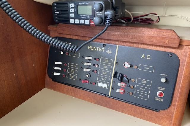 Control panel of a 1990 Hunter 27 sailboat with radio equipment.
