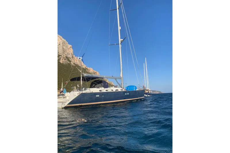  Yacht Photos Pics Beneteau Oceanis Clipper 523 yacht sailing near rocky coastline, 2004 model.