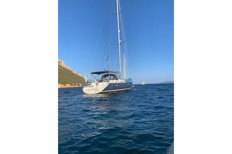  Yacht Photos Pics Sailing yacht Beneteau Oceanis Clipper 523, 2004 model, anchored in clear blue waters.