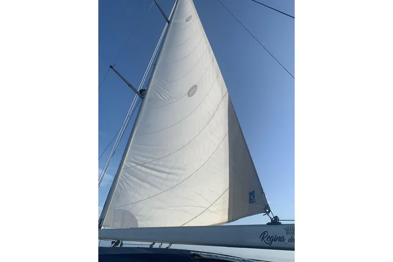  Yacht Photos Pics Sail of a 2004 Beneteau Oceanis Clipper 523 against a clear blue sky.