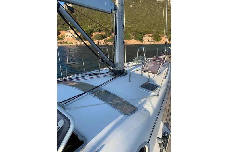  Yacht Photos Pics 2004 Beneteau Oceanis Clipper 523 sailboat deck with scenic coastal backdrop.