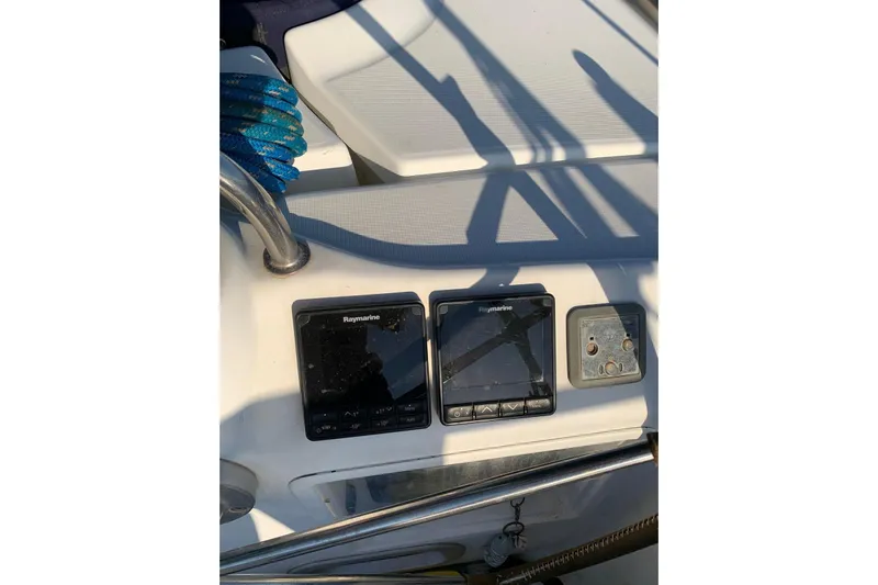  Yacht Photos Pics Control panel of 2004 Beneteau Oceanis Clipper 523 with Raymarine displays and blue rope.