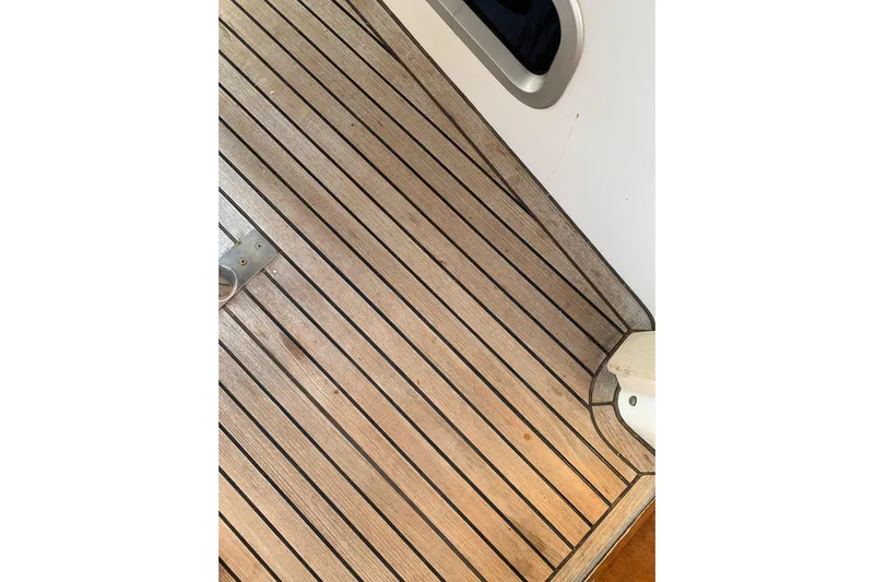  Yacht Photos Pics Teak deck of 2004 Beneteau Oceanis Clipper 523 sailboat, featuring sleek wood finish.