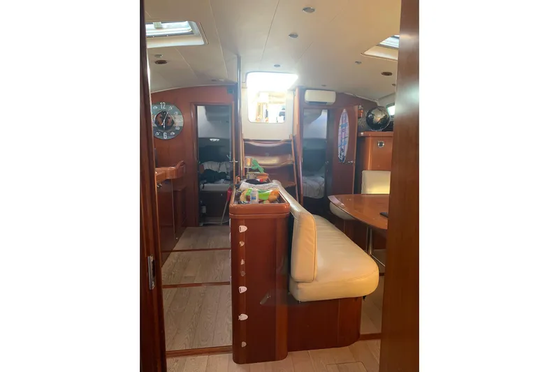  Yacht Photos Pics Interior of 2004 Beneteau Oceanis Clipper 523 yacht with wooden furnishings and seating.