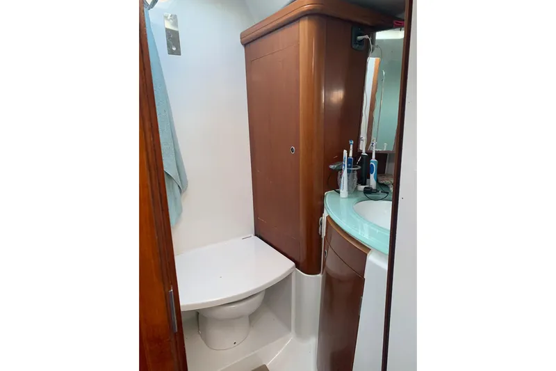  Yacht Photos Pics Bathroom interior of 2004 Beneteau Oceanis Clipper 523 yacht, featuring wooden cabinetry and modern fixtures.