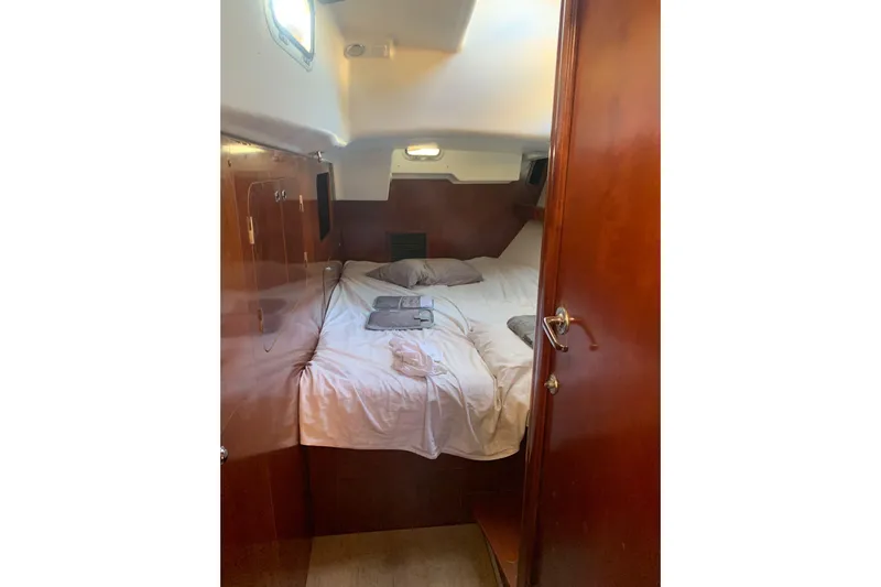  Yacht Photos Pics Cozy cabin interior of 2004 Beneteau Oceanis Clipper 523 sailboat with wooden finish.