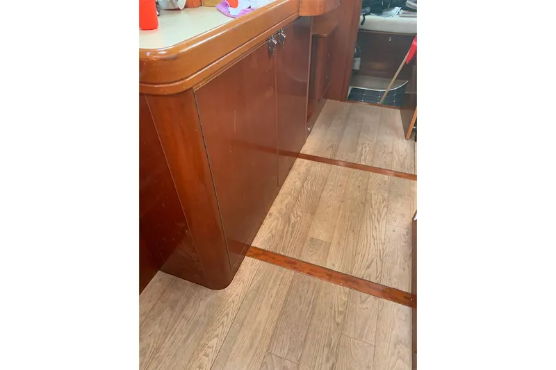 Yacht Photos Pics Interior of 2004 Beneteau Oceanis Clipper 523, featuring wooden cabinetry and flooring.
