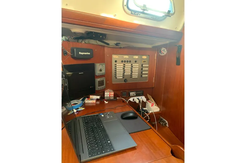  Yacht Photos Pics Navigation station on 2004 Beneteau Oceanis Clipper 523 with electronics and laptop.