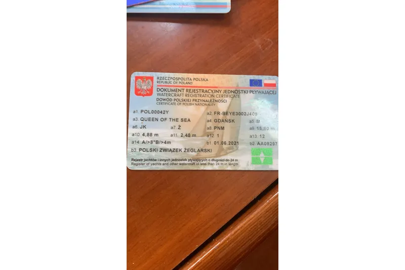  Yacht Photos Pics Polish watercraft registration certificate on wooden surface, for Beneteau Oceanis Clipper 523, 2004.