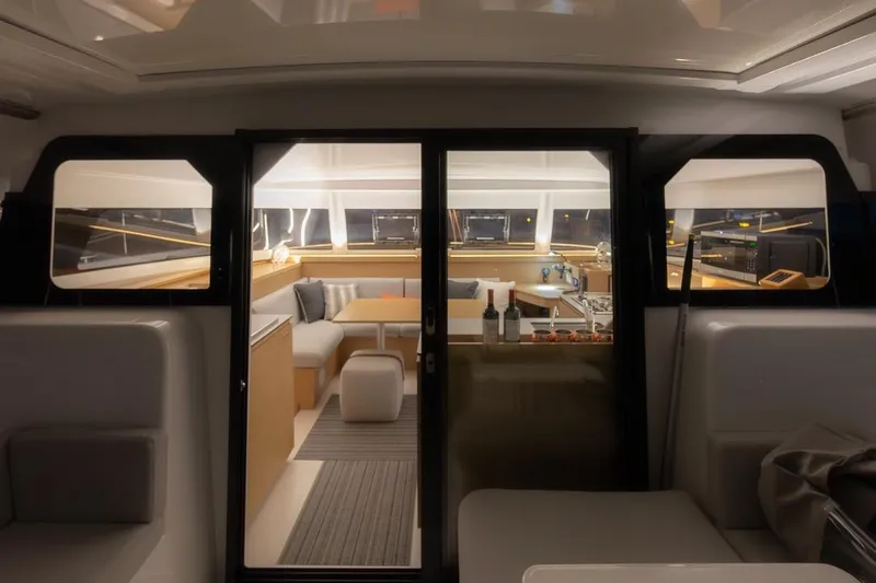 Eli X Yacht Photos Pics Luxurious interior of 2023 Excess 11 yacht with modern seating and dining area.