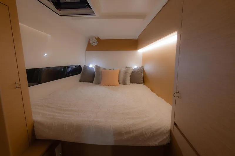 Eli X Yacht Photos Pics Luxurious cabin interior of 2023 Excess 11 yacht with cozy bedding and ambient lighting.