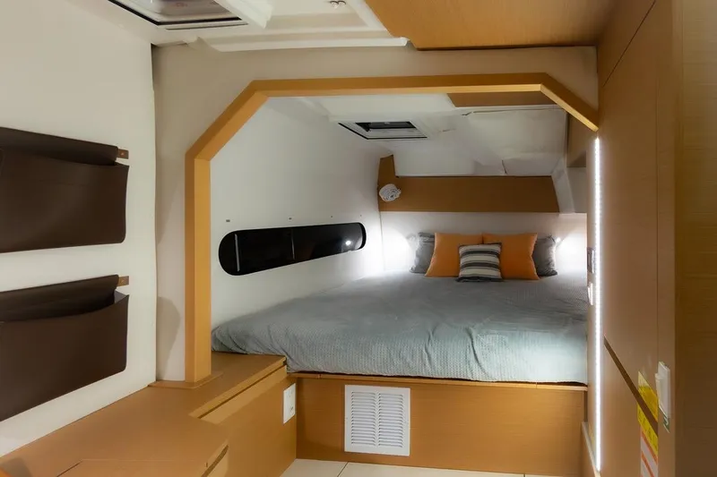 Eli X Yacht Photos Pics Modern cabin interior of 2023 Excess 11 yacht with cozy bed and stylish decor.
