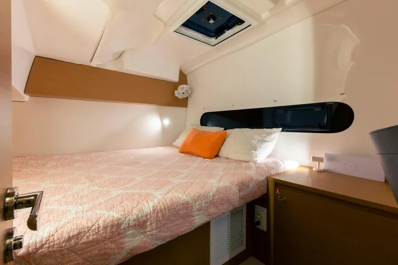 Eli X Yacht Photos Pics Cozy cabin interior of 2023 Excess 11 yacht with bed and window.