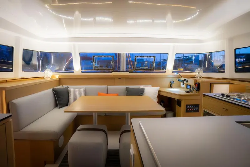 Eli X Yacht Photos Pics Luxurious interior of 2023 Excess 11 catamaran with modern seating and panoramic windows.