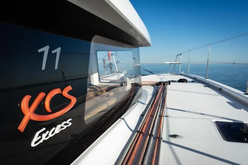 Eli X Yacht Photos Pics Sleek 2023 Excess 11 catamaran on calm sea, showcasing modern design and branding.