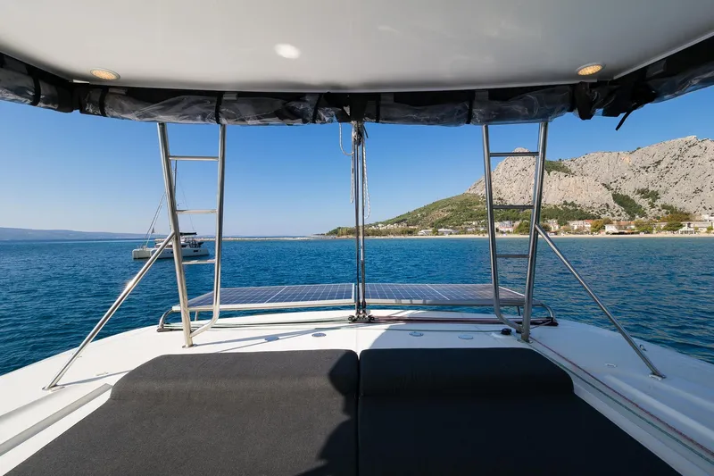 Almissa Yacht Photos Pics View from Lagoon 46 yacht, 2023 model, overlooking serene blue waters and coastal landscape.