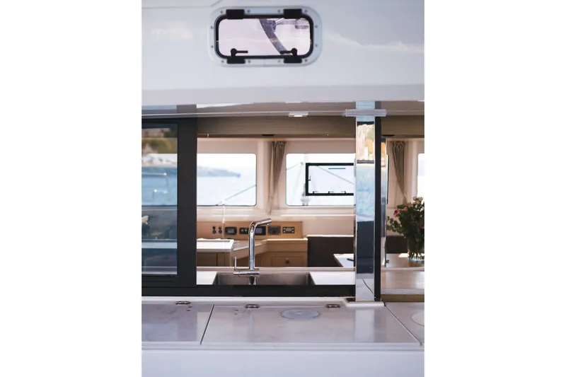 Almissa Yacht Photos Pics Interior view of 2023 Lagoon 46 yacht, featuring modern kitchen and window.