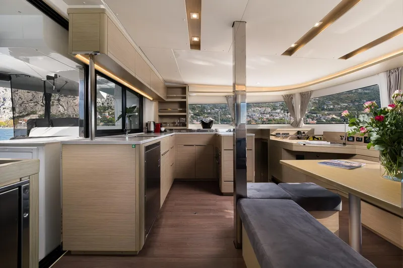 Almissa Yacht Photos Pics Luxurious interior of 2023 Lagoon 46 yacht with modern kitchen and seating area.