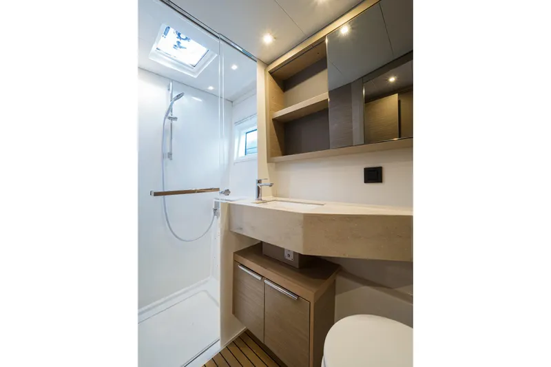 Almissa Yacht Photos Pics Modern bathroom interior of 2023 Lagoon 46 yacht with shower and wooden accents.