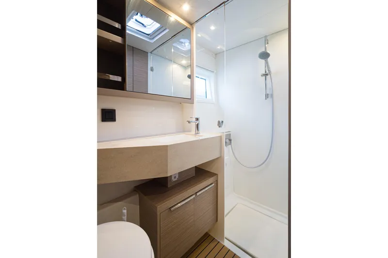 Almissa Yacht Photos Pics Modern bathroom in 2023 Lagoon 46 yacht, featuring sleek shower and vanity design.