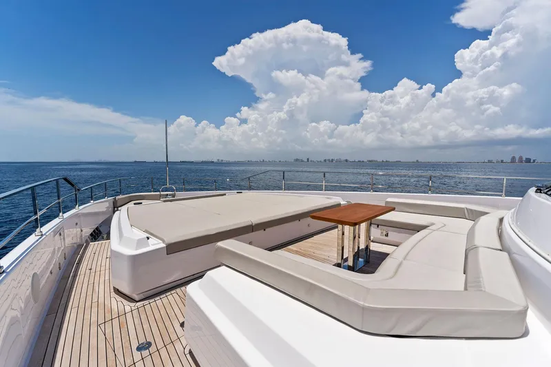 Double Up Yacht Photos Pics Luxurious 2024 Custom Line Navetta 33 yacht deck with seating, ocean view, and clear skies.