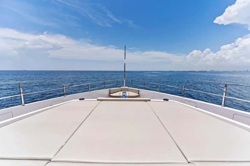 Double Up Yacht Photos Pics Custom Line Navetta 33 yacht deck, 2024 model, cruising on open sea under clear blue sky.