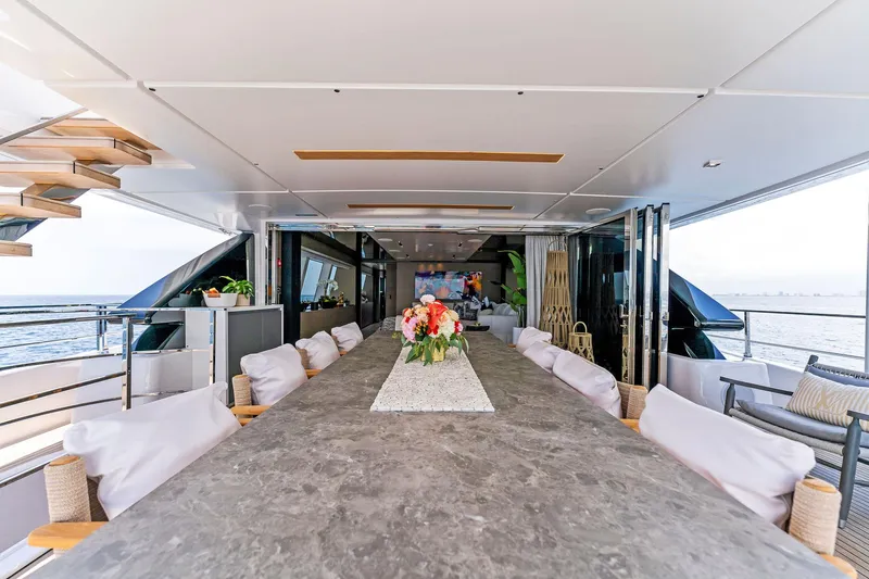 Double Up Yacht Photos Pics Luxurious 2024 Custom Line Navetta 33 yacht interior with elegant dining area and ocean view.