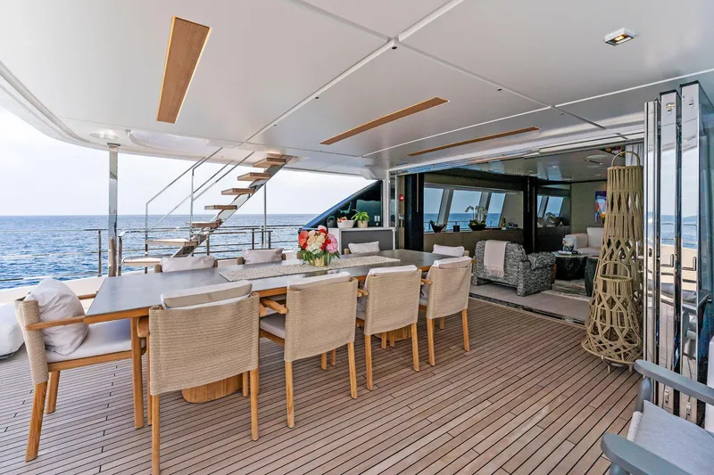 Double Up Yacht Photos Pics Luxurious 2024 Custom Line Navetta 33 yacht deck with elegant dining area and ocean view.