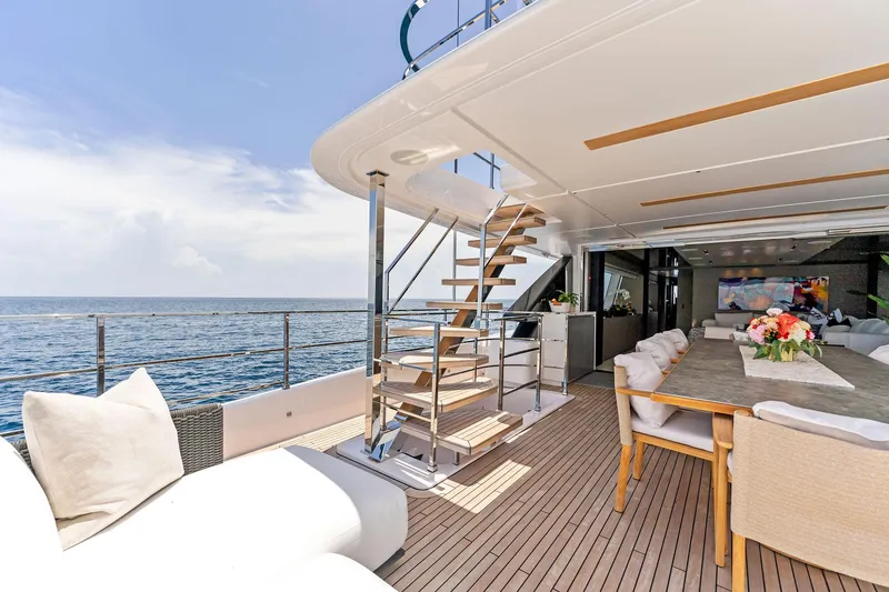 Double Up Yacht Photos Pics Luxurious 2024 Custom Line Navetta 33 yacht with elegant outdoor dining area and ocean view.