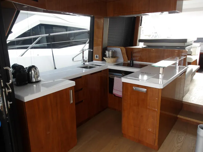  Yacht Photos Pics Modern kitchen interior on 2023 Galeon 500 Fly yacht with sleek wooden cabinetry.