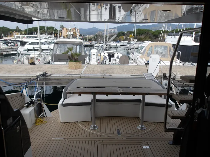  Yacht Photos Pics 2023 Galeon 500 Fly yacht docked at a marina, showcasing its spacious deck area.
