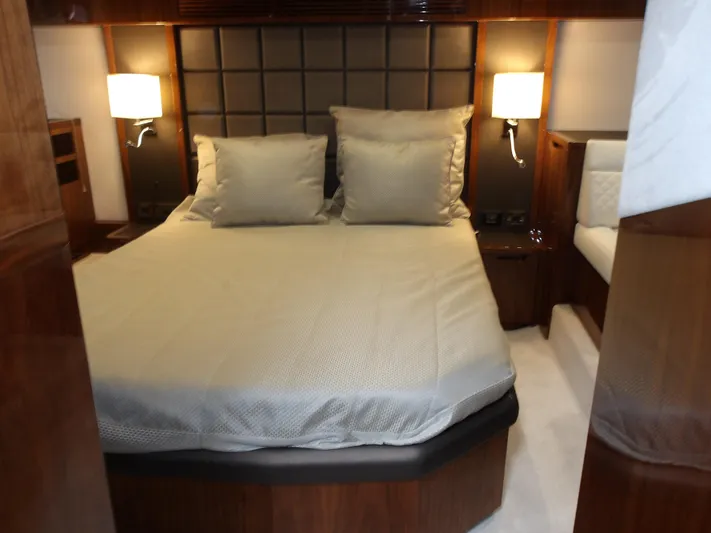  Yacht Photos Pics Luxurious bedroom interior of 2023 Galeon 500 Fly yacht with elegant bedding and warm lighting.