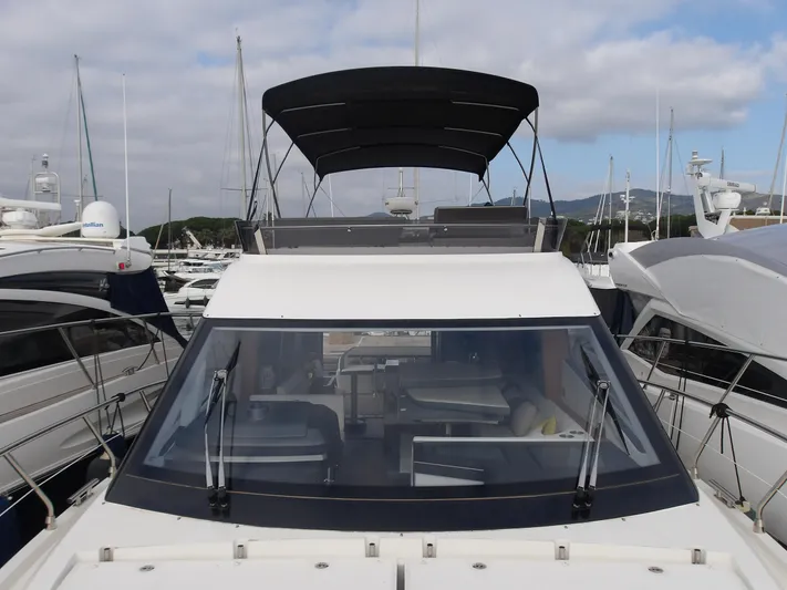  Yacht Photos Pics 2023 Galeon 500 Fly yacht docked in marina, front view with flybridge canopy.