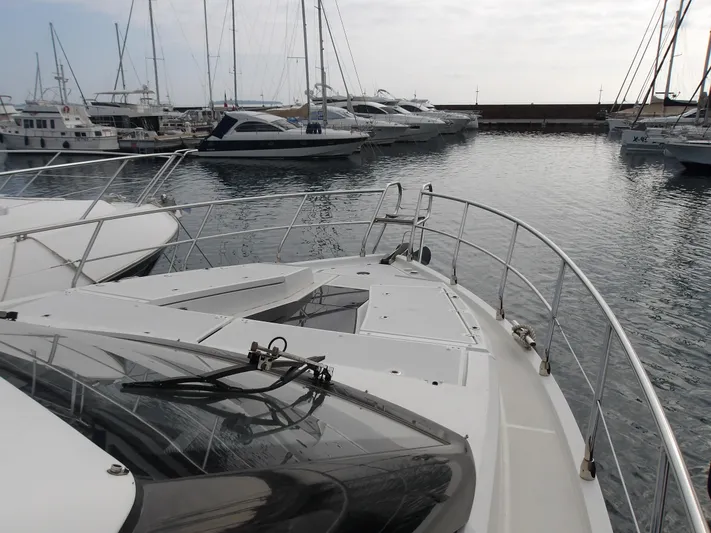  Yacht Photos Pics 2023 Galeon 500 Fly yacht docked in a marina with other boats.