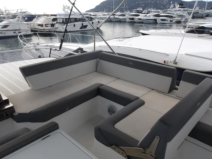  Yacht Photos Pics 2023 Galeon 500 Fly yacht with spacious seating area in a marina setting.