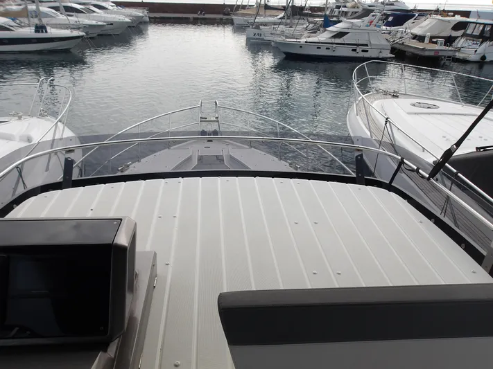  Yacht Photos Pics 2023 Galeon 500 Fly yacht docked in a marina, surrounded by other boats.