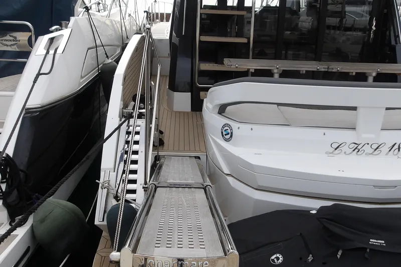  Yacht Photos Pics 2023 Galeon 500 Fly yacht with boarding ramp and sleek design.