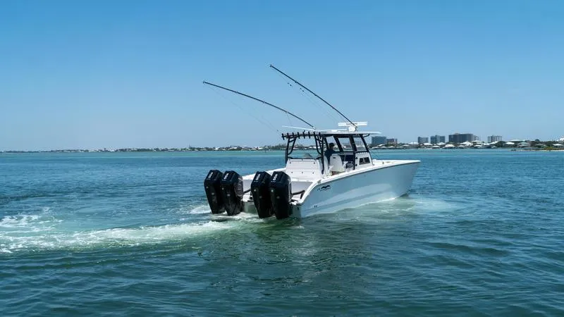  Yacht Photos Pics 2024 Invincible 40' Catamaran cruising on open water with twin outboard engines.