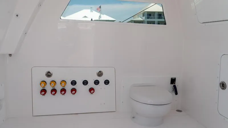  Yacht Photos Pics 2024 Invincible 40' Catamaran interior with control panel and toilet.