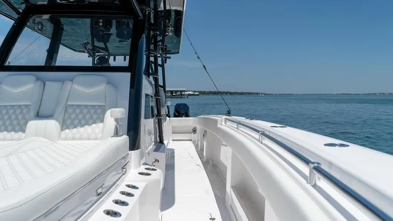  Yacht Photos Pics 2024 Invincible 40' Catamaran with luxurious white seating on calm waters.