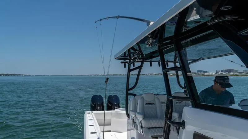  Yacht Photos Pics 2024 Invincible 40' Catamaran on open water with fishing gear.