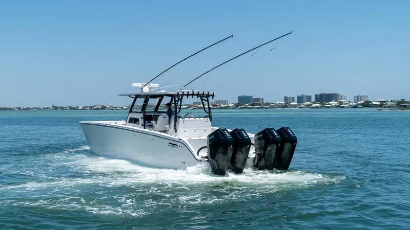  Yacht Photos Pics 2024 Invincible 40' Catamaran with triple outboard engines cruising on the water.