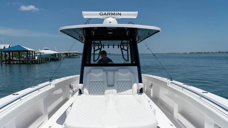  Yacht Photos Pics 2024 Invincible 40' Catamaran on calm waters with Garmin navigation system.