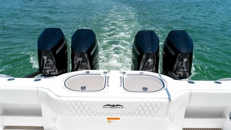  Yacht Photos Pics 2024 Invincible 40' Catamaran with quad Mercury outboard engines on the water.
