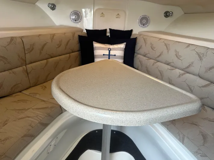 Irie Yacht Photos Pics 2006 Hydra-Sports Vector 2900 VX cabin interior with cushioned seating and table.