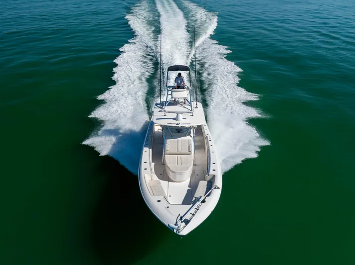 Double Bird Yacht Photos Pics 2020 Contender 44 ST boat cruising on open water, aerial view.