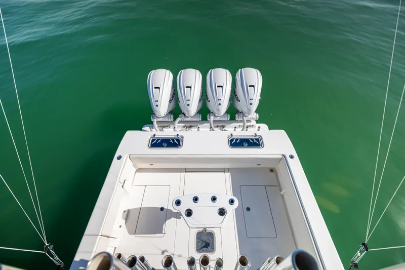 Double Bird Yacht Photos Pics Contender 44 ST 2020 boat with four engines on calm green water.
